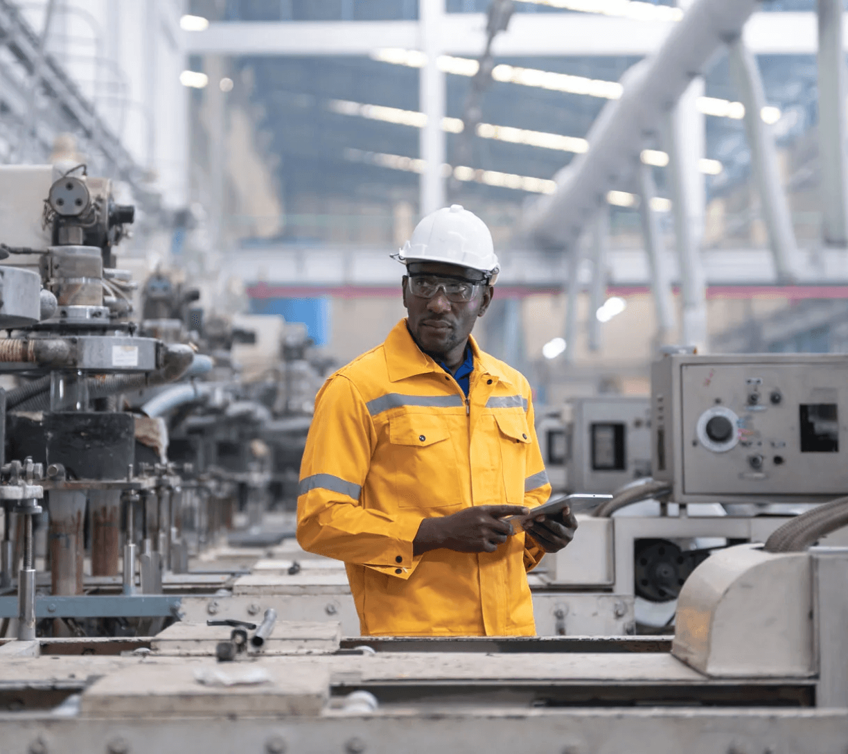 Engineer in safety gear reviewing data on a tablet